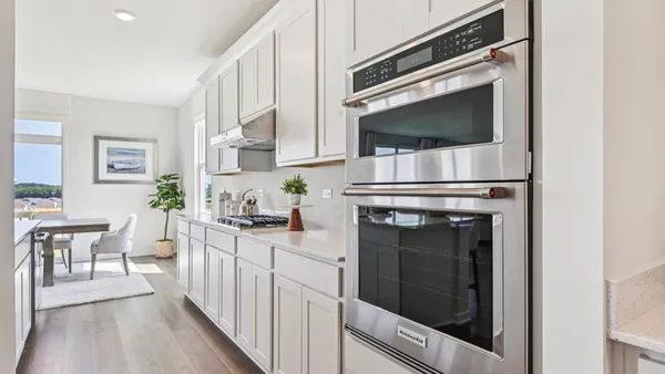 a kitchen with counter top space a sink appliances and cabinets