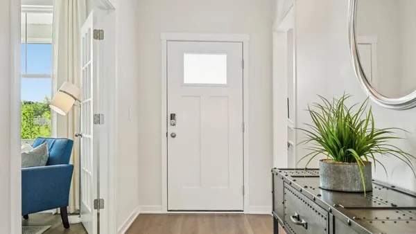 a view of a hallway with potted plant and a window