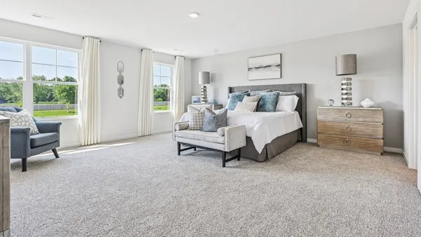 a bedroom with a bed and a wall painting