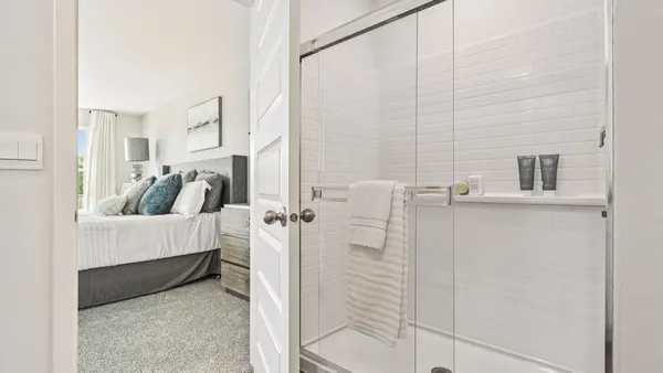 a spacious bedroom with a bed and a table