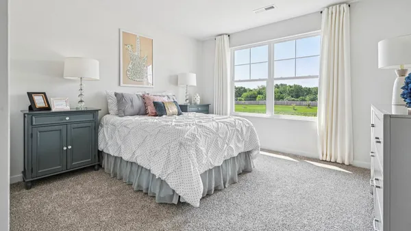 a bed room with a bed and a window