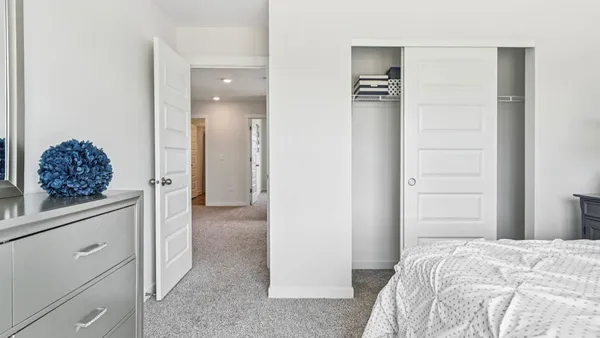 a bed room with a bed and a mirror