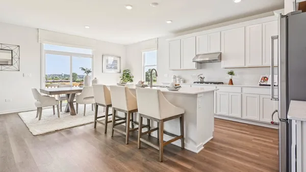 a kitchen with stainless steel appliances granite countertop a white cabinets and wooden floor