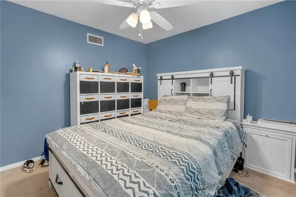 a bedroom with a bed and a lamp
