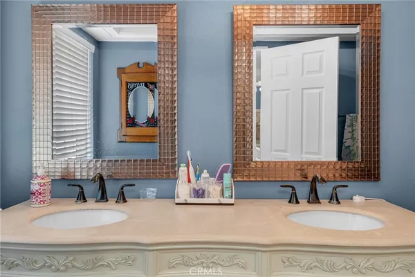 a bedroom with two beds and a chandelier