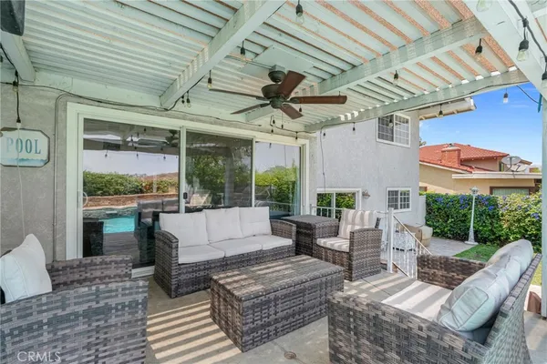 a view of a patio with couches chairs potted plants and a table