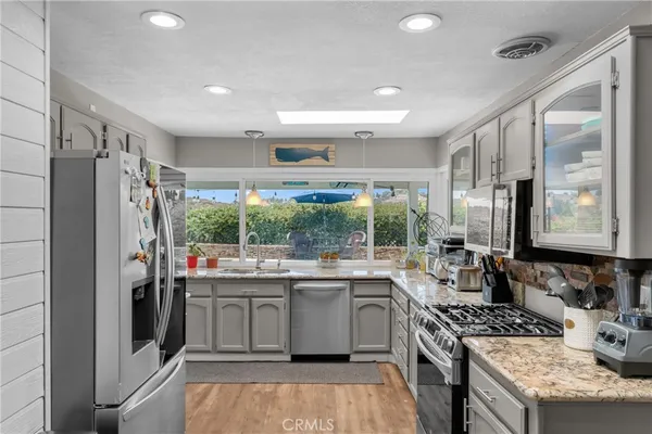 a kitchen with a sink stove and refrigerator