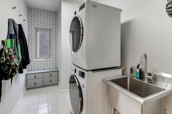 a utility room with a sink a washer and dryer