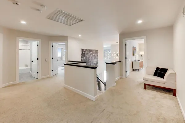 a living room with furniture and kitchen view