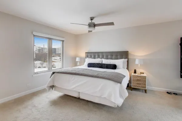 a bedroom with a bed and window