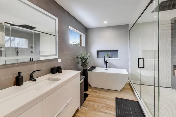 a bathroom with a sink a mirror and a bathtub