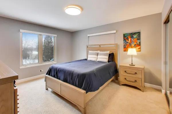 a spacious bedroom with a bed and a window