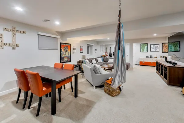 a living room with furniture a flat screen tv and a table