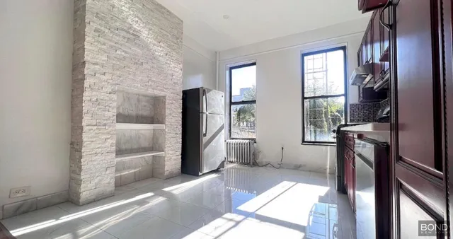 a living room with a fireplace furniture and a large window