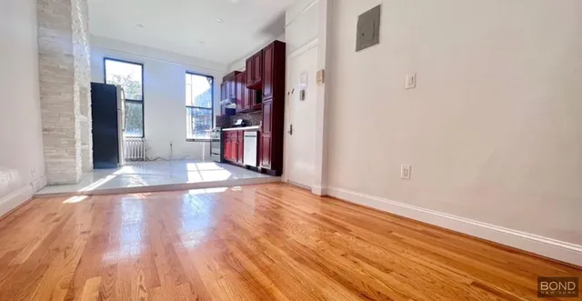 a view of a room with wooden floor