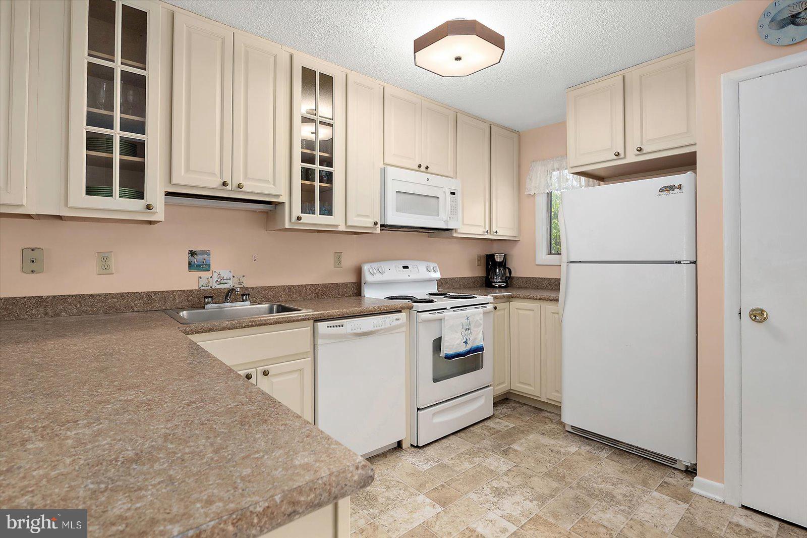 614 Osprey Road, Unit D Ocean City, MD 21842 - Photo 14 of 60 a kitchen with appliances cabinets and a sink