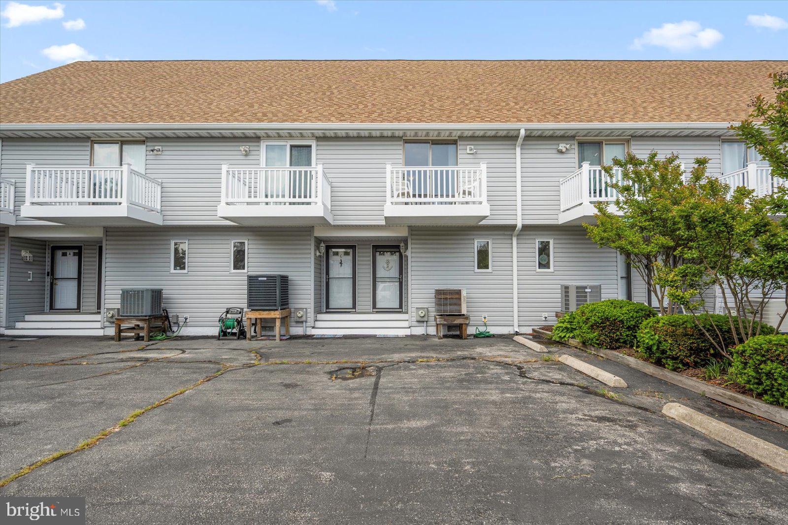 614 Osprey Road, Unit D Ocean City, MD 21842 - Photo 2 of 60 a front view of a house with yard and parking space