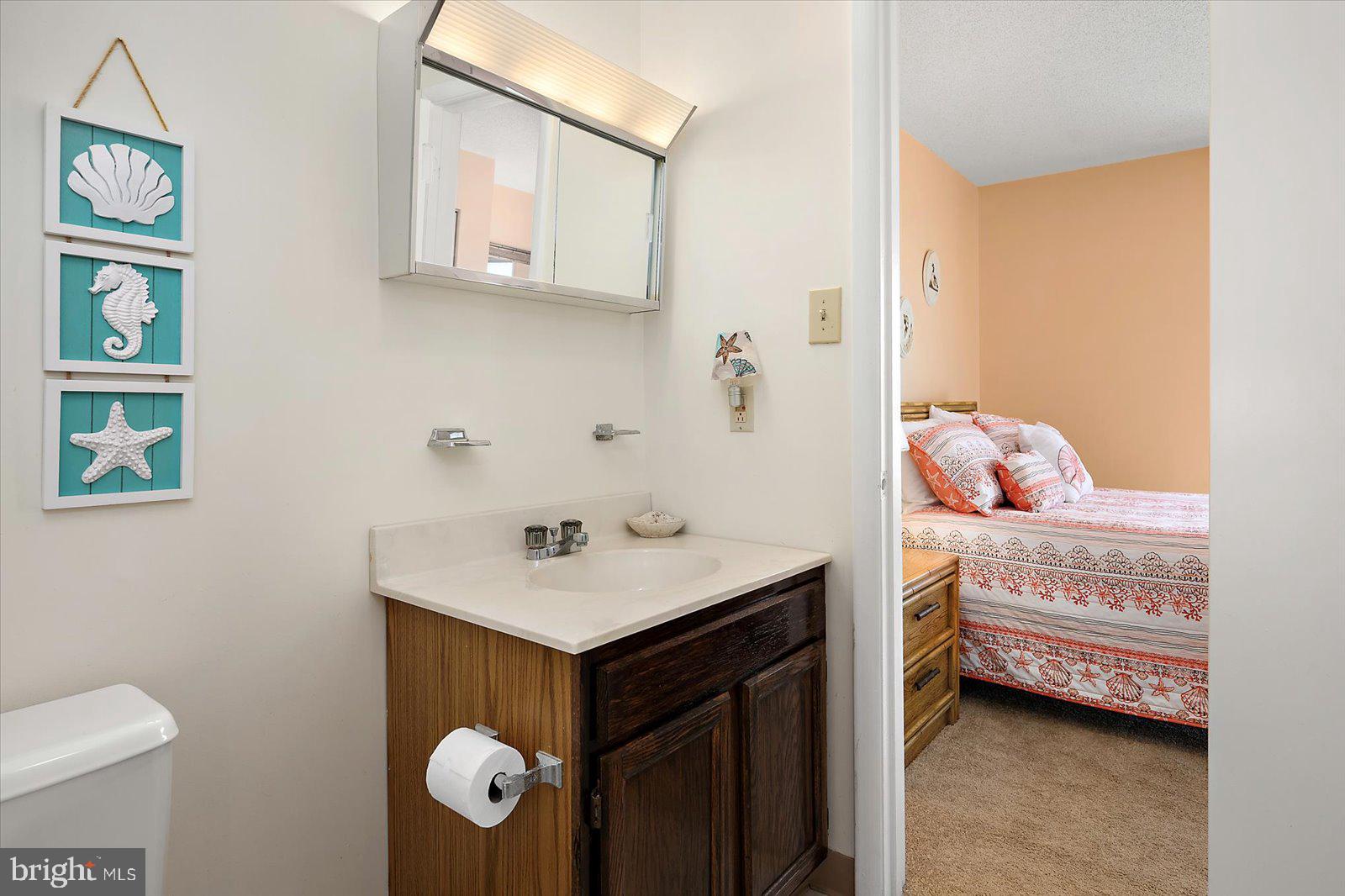 614 Osprey Road, Unit D Ocean City, MD 21842 - Photo 24 of 60 a bathroom with a sink toilet and a mirror
