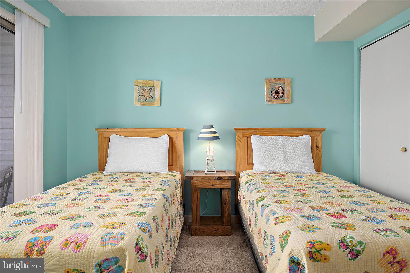 614 Osprey Road, Unit D Ocean City, MD 21842 - Photo 27 of 60 a bedroom with two beds and painting on the wall