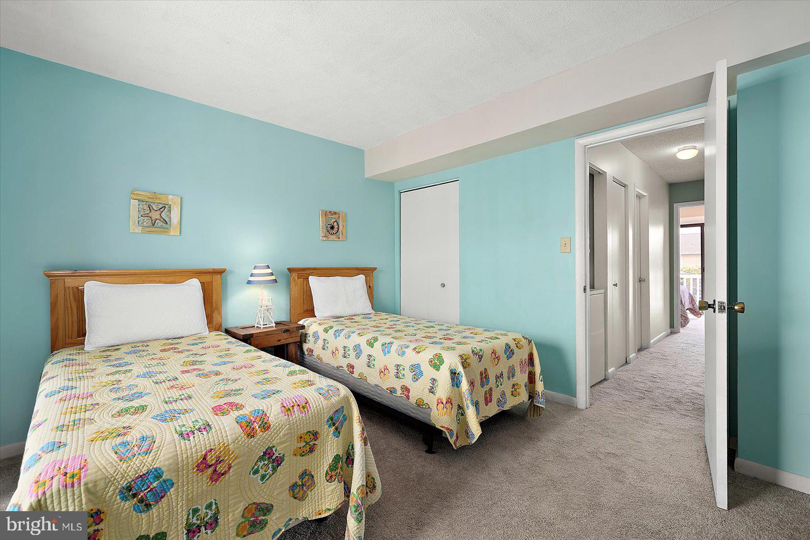614 Osprey Road, Unit D Ocean City, MD 21842 - Photo 28 of 60 a bedroom with two beds and painting on the wall
