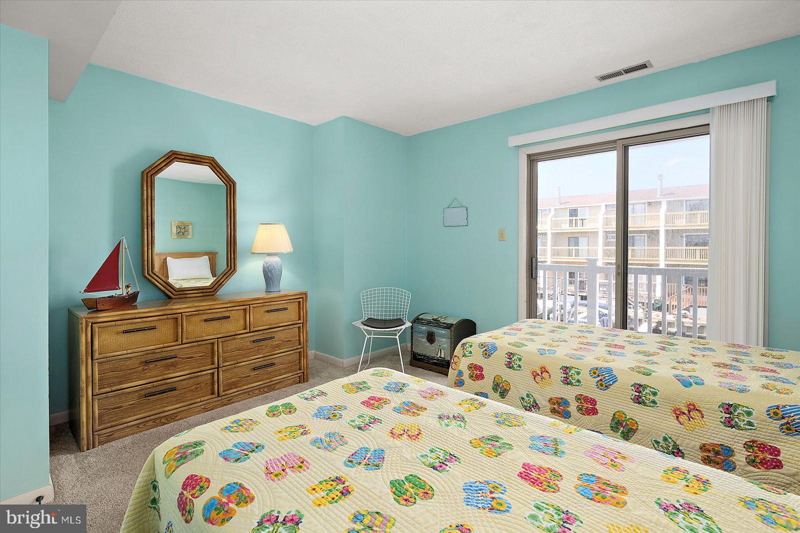614 Osprey Road, Unit D Ocean City, MD 21842 - Photo 29 of 60 a bedroom with a bed and a dresser