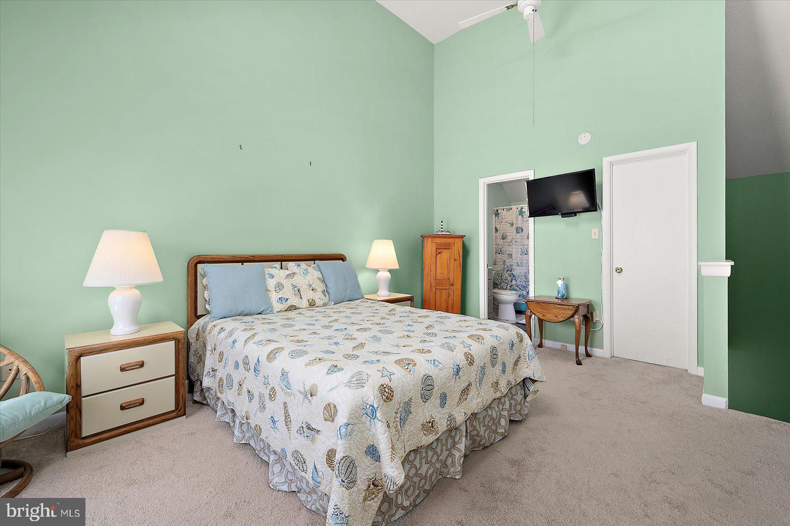 614 Osprey Road, Unit D Ocean City, MD 21842 - Photo 33 of 60 a bedroom with a bed and a lamp