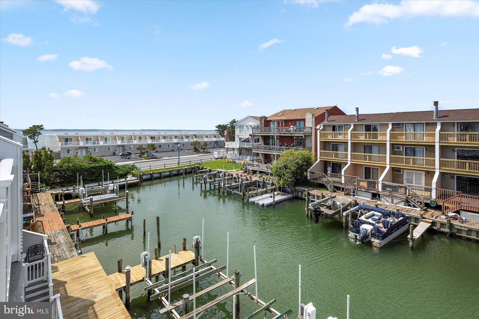 614 Osprey Road, Unit D Ocean City, MD 21842 - Photo 39 of 60 a view of a lake with tall buildings