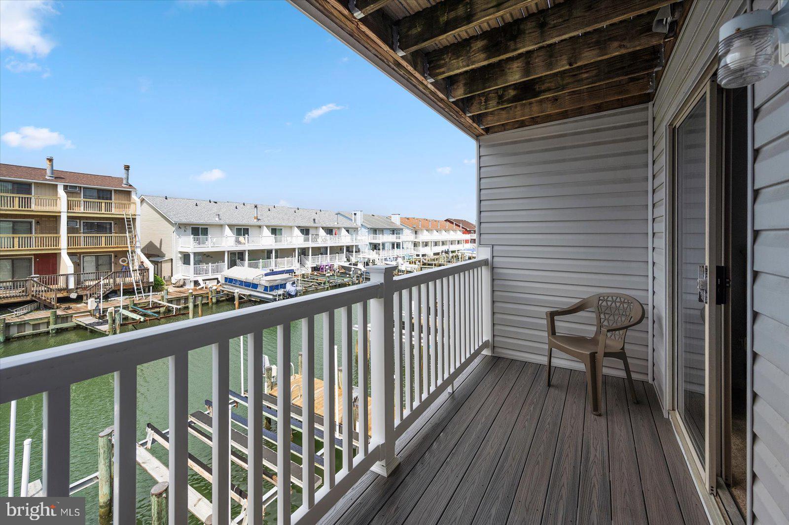 614 Osprey Road, Unit D Ocean City, MD 21842 - Photo 42 of 60 a view of a balcony with chair and wooden floor
