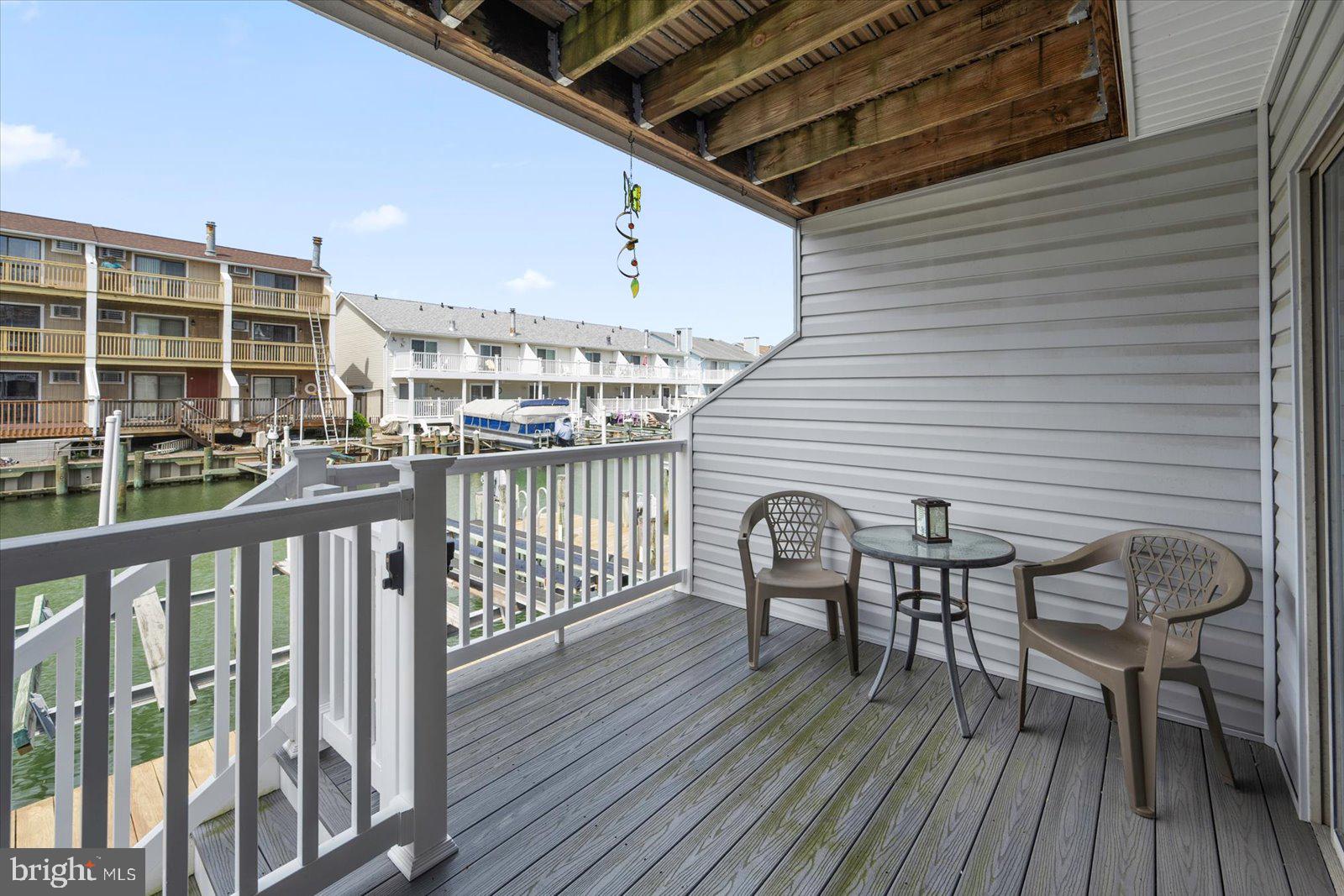 614 Osprey Road, Unit D Ocean City, MD 21842 - Photo 48 of 60 a view of a chairs and table on the deck