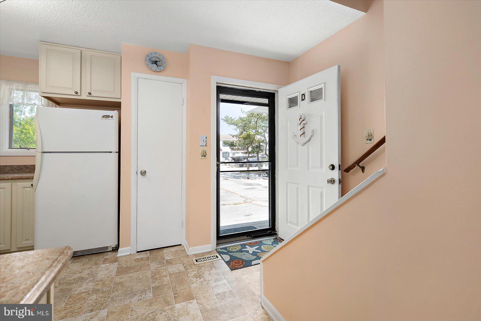 614 Osprey Road, Unit D Ocean City, MD 21842 - Photo 5 of 60 a view of a kitchen with refrigerator and cabinet