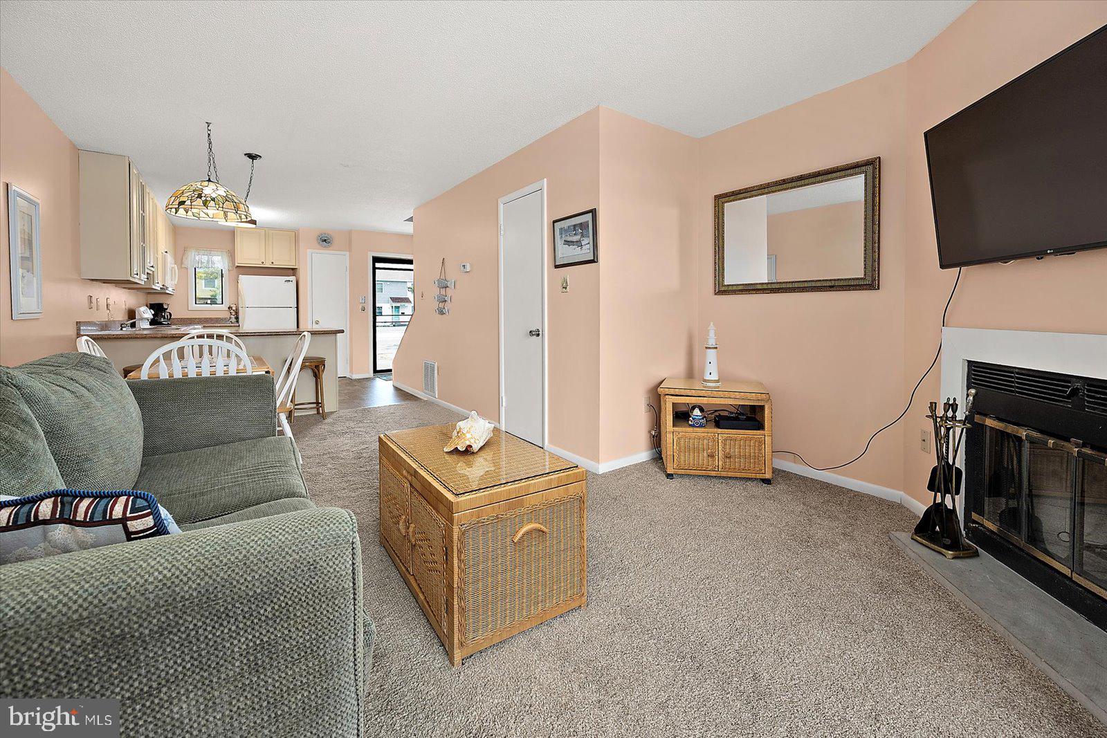 614 Osprey Road, Unit D Ocean City, MD 21842 - Photo 10 of 60 a living room with furniture and a fireplace