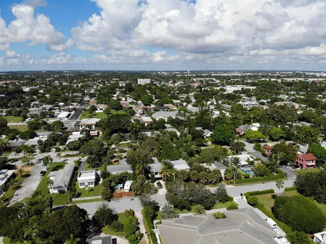 an aerial view of a residential houses with city view