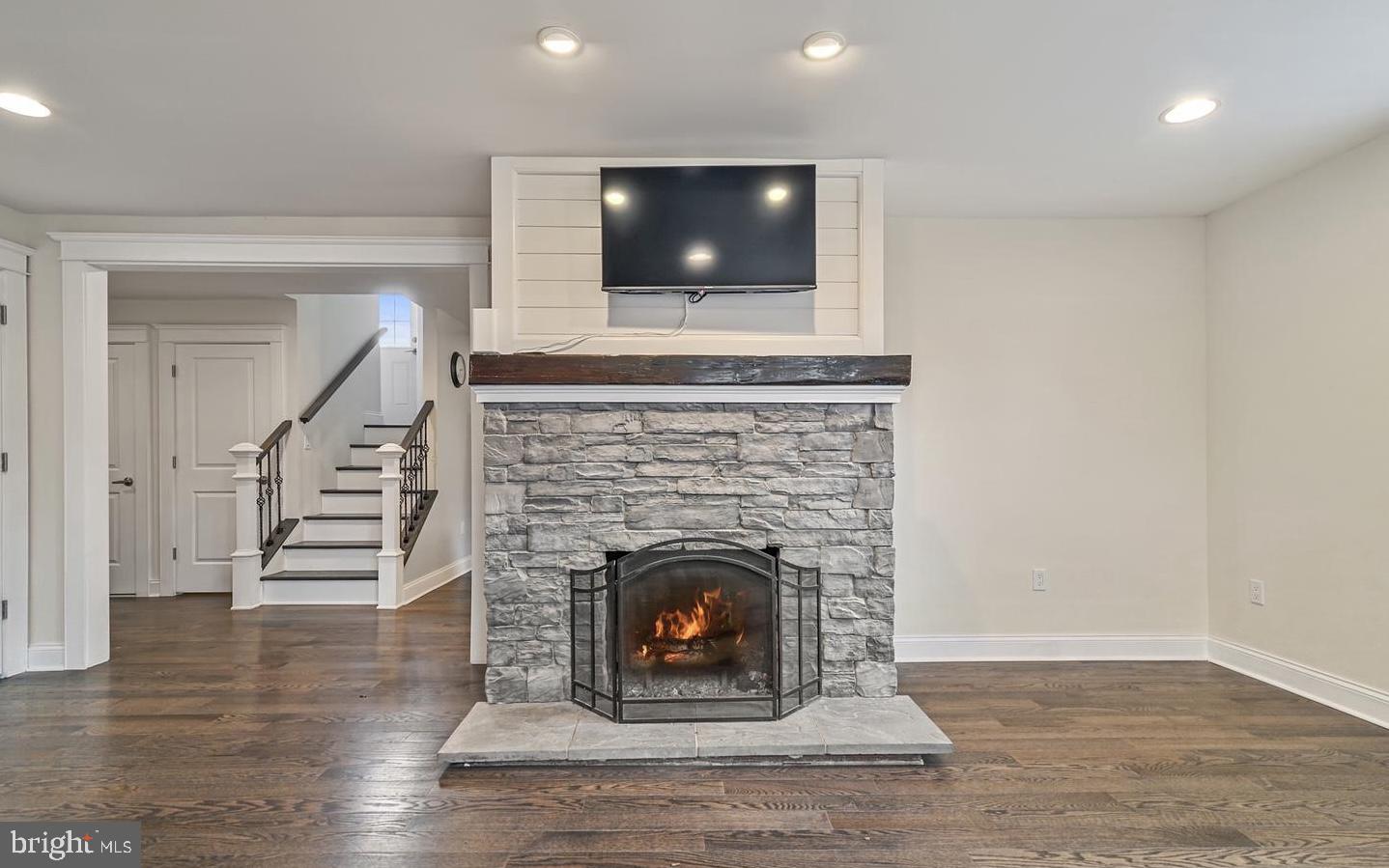 14161 Union Street Milton, DE 19968 - Photo 12 of 31 a living room with a fireplace and a floor to ceiling window