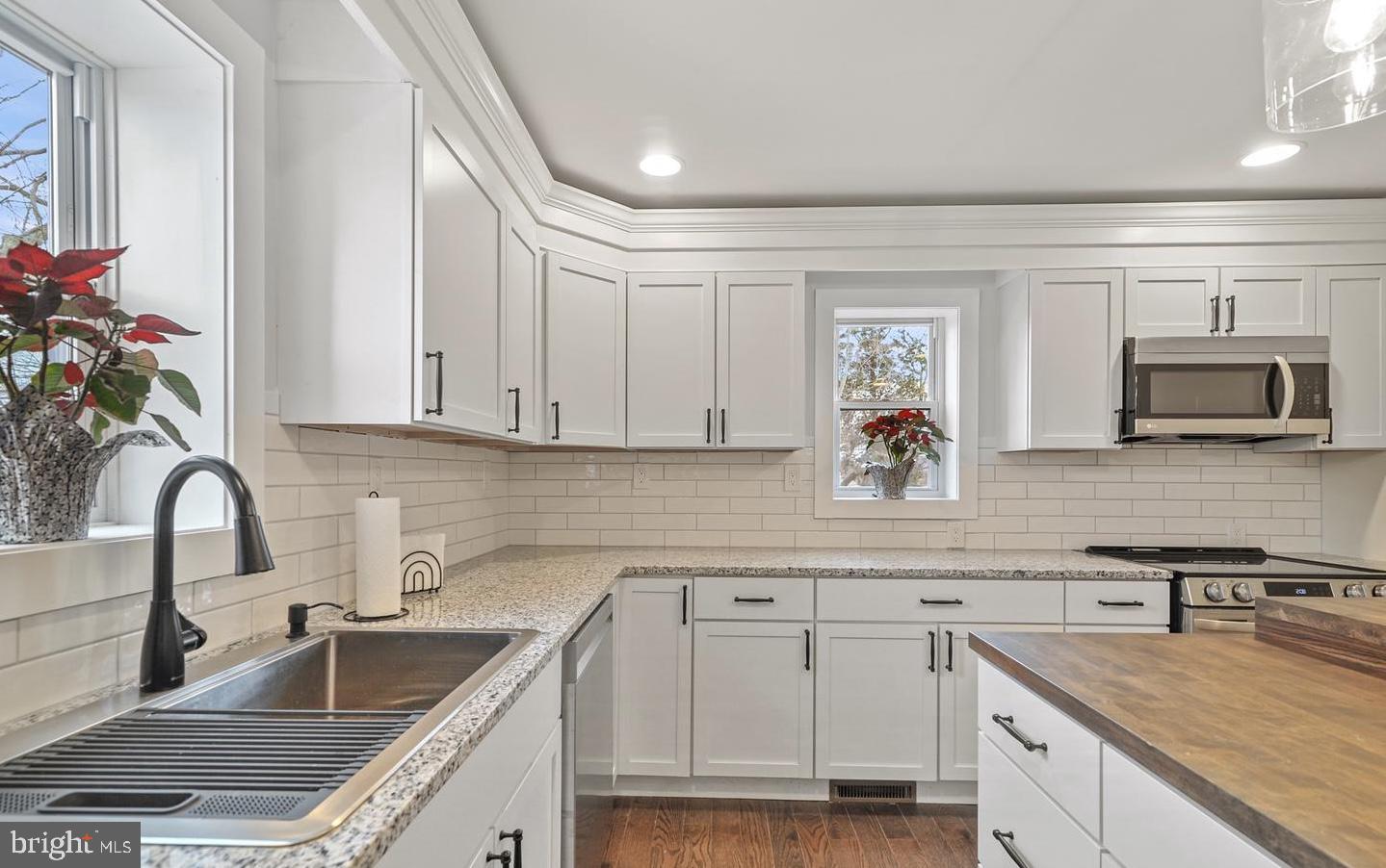 14161 Union Street Milton, DE 19968 - Photo 6 of 31 a kitchen with granite countertop a sink stainless steel appliances and cabinets