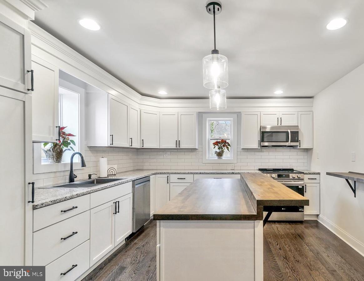 14161 Union Street Milton, DE 19968 - Photo 7 of 31 a kitchen that has a lot of cabinets in it and wooden floors