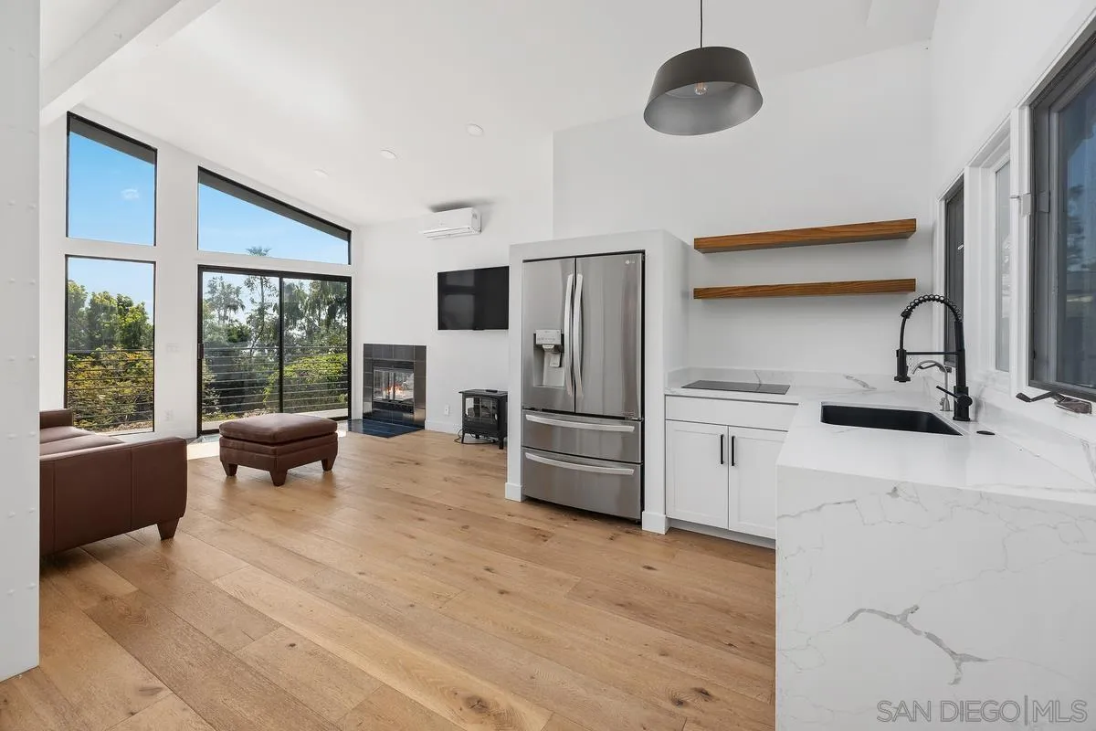 16610 Los Morros Rancho Santa Fe, CA 92067 - Photo 28 of 50 a kitchen with stainless steel appliances granite countertop a stove a refrigerator and a fireplace with wooden floor