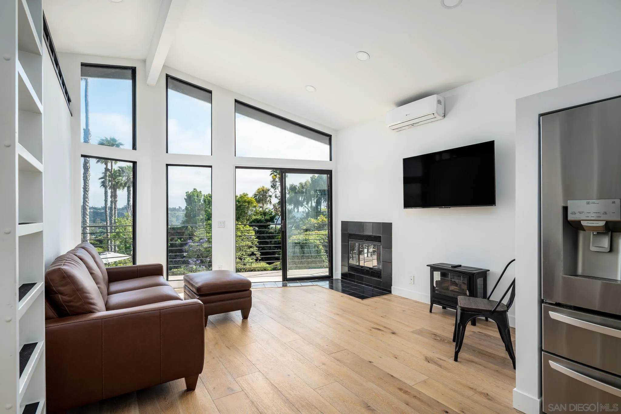 16610 Los Morros Rancho Santa Fe, CA 92067 - Photo 29 of 50 a living room with furniture a fireplace and a flat screen tv