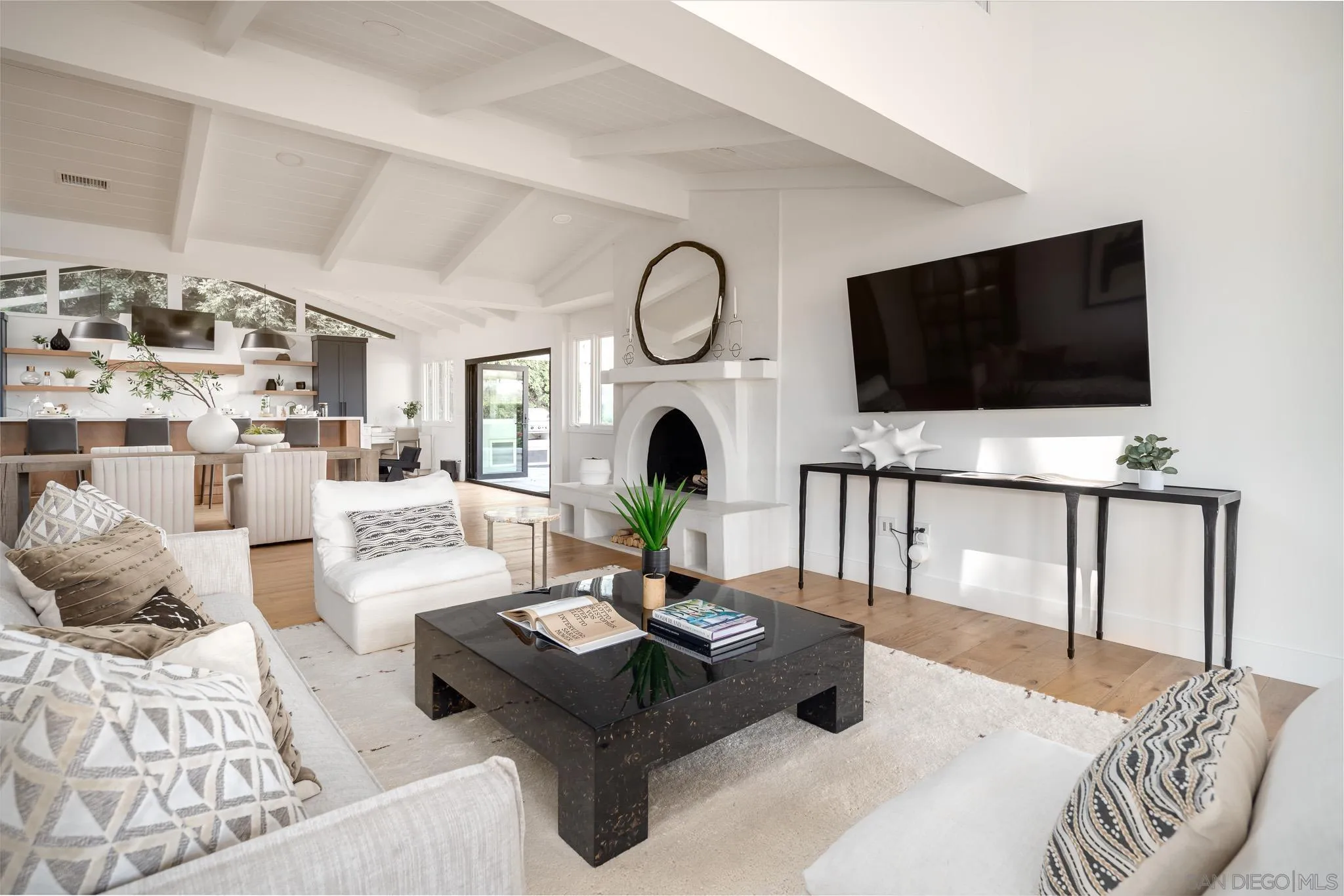 16610 Los Morros Rancho Santa Fe, CA 92067 - Photo 5 of 50 a living room with furniture a flat screen tv and a fireplace