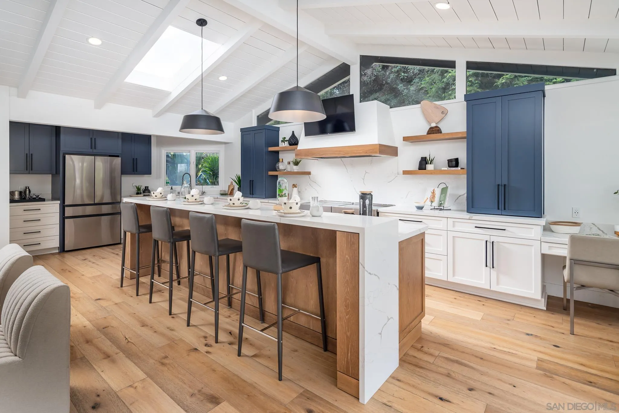 16610 Los Morros Rancho Santa Fe, CA 92067 - Photo 7 of 50 a kitchen with stainless steel appliances kitchen island granite countertop a table chairs sink and cabinets