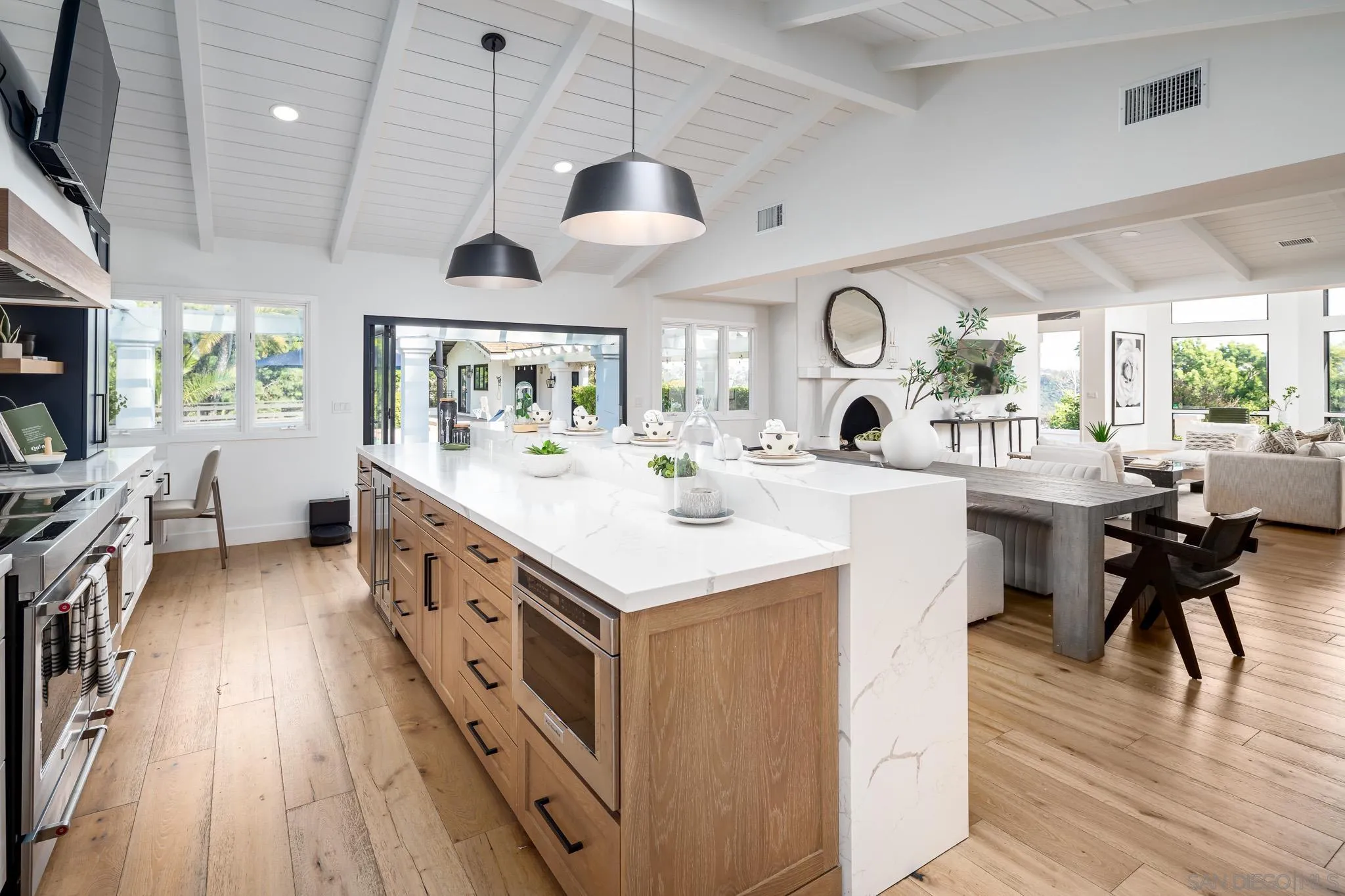 16610 Los Morros Rancho Santa Fe, CA 92067 - Photo 9 of 50 a kitchen with stainless steel appliances kitchen island a large island in the center