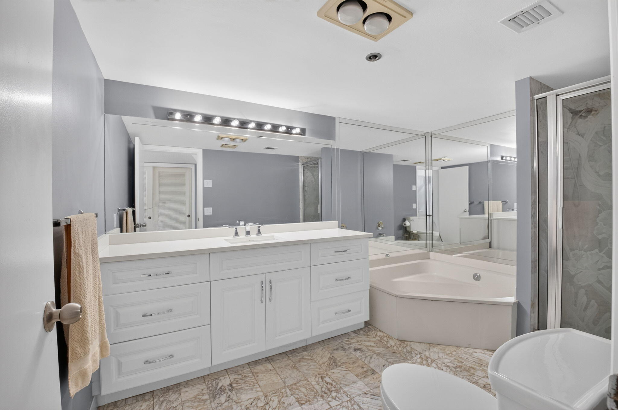 1401 South Ocean Boulevard, Unit 1060 Boca Raton, FL 33432 - Photo 20 of 46 a bathroom with a toilet a sink a mirror a bathtub and shower