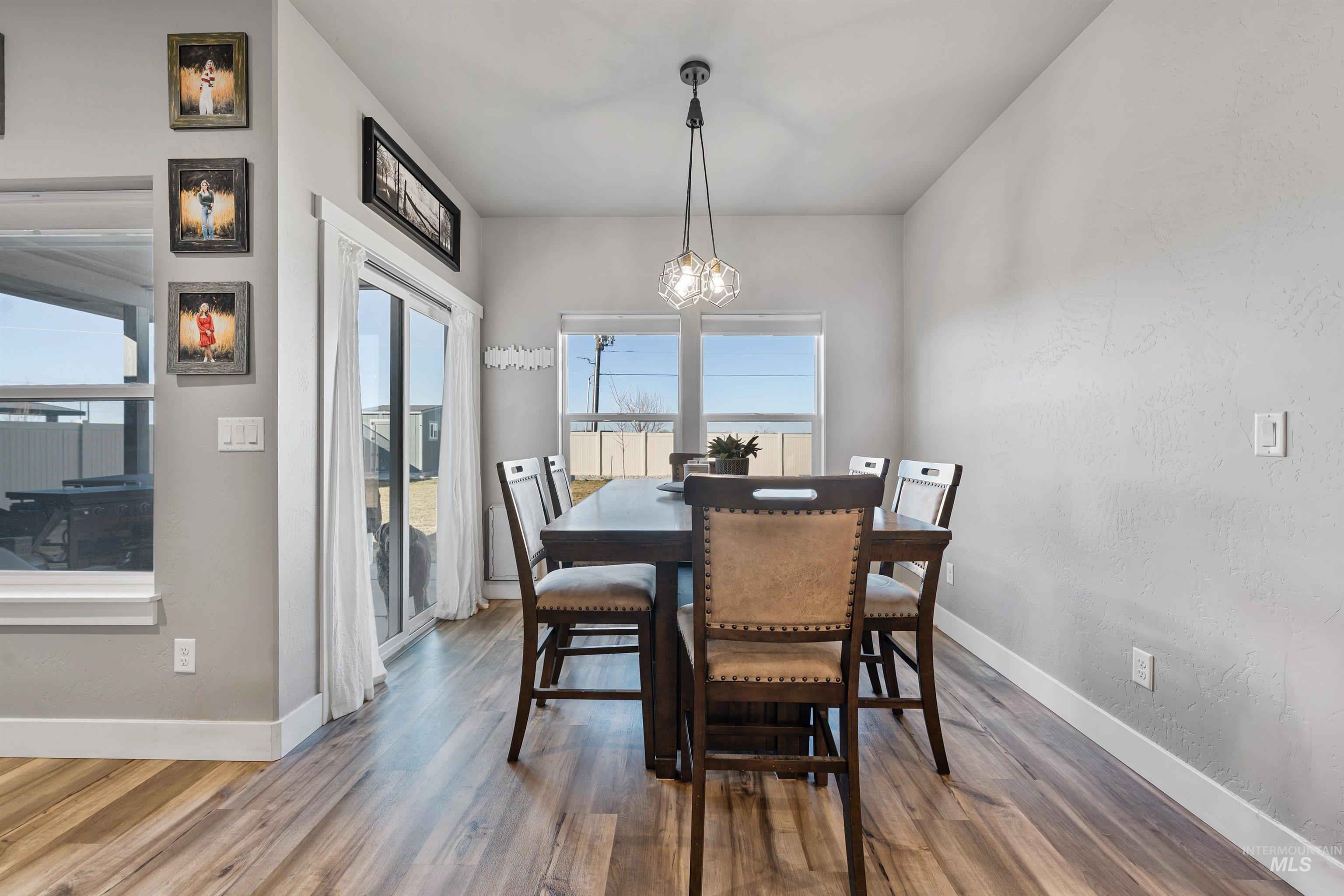 1005 Kenbrook Loop Twin Falls, ID 83301 - Photo 10 of 47 Dining room featuring wood finished floors, hanging lights, and a textured wall