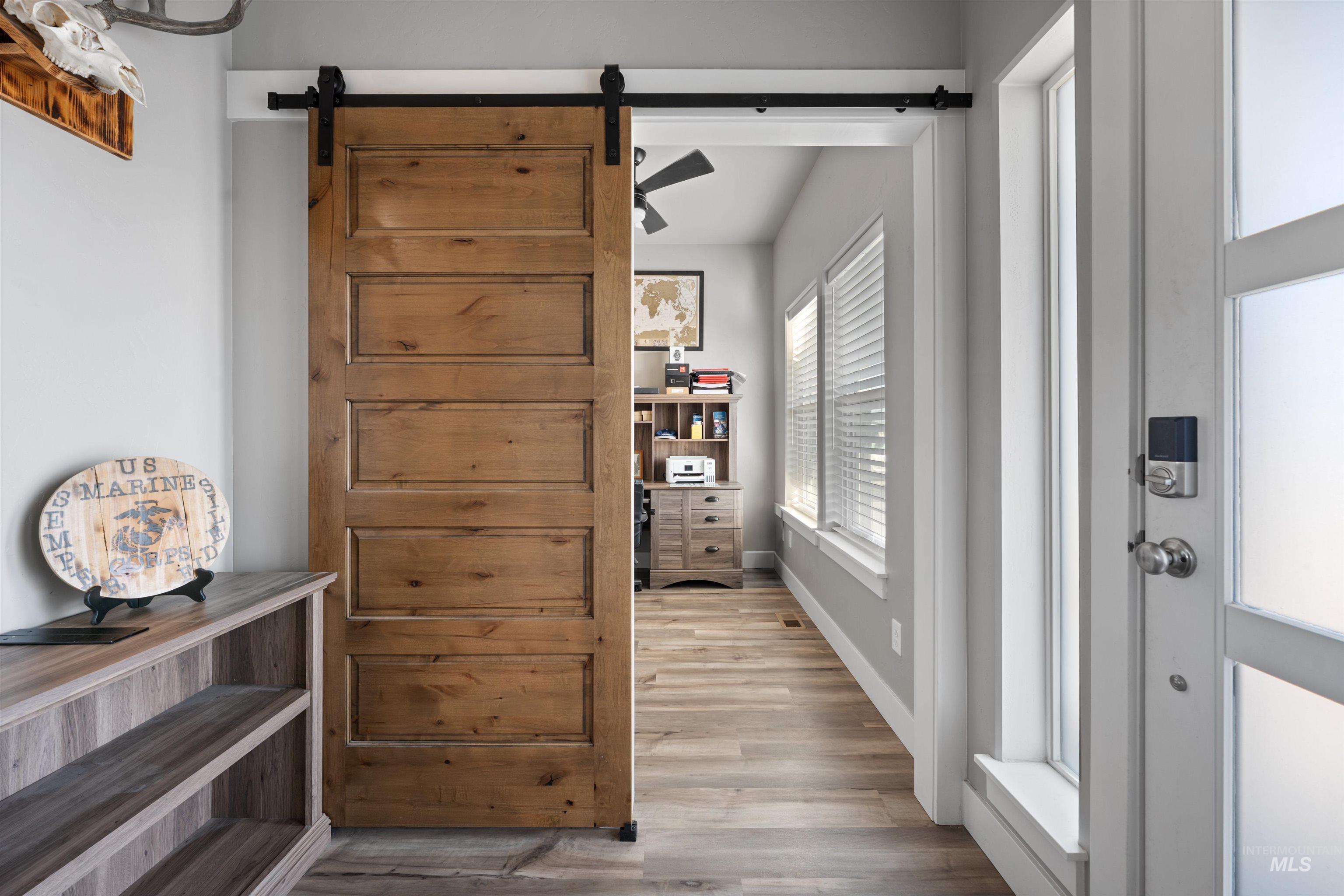 1005 Kenbrook Loop Twin Falls, ID 83301 - Photo 11 of 47 Corridor with a barn door and light wood finished floors