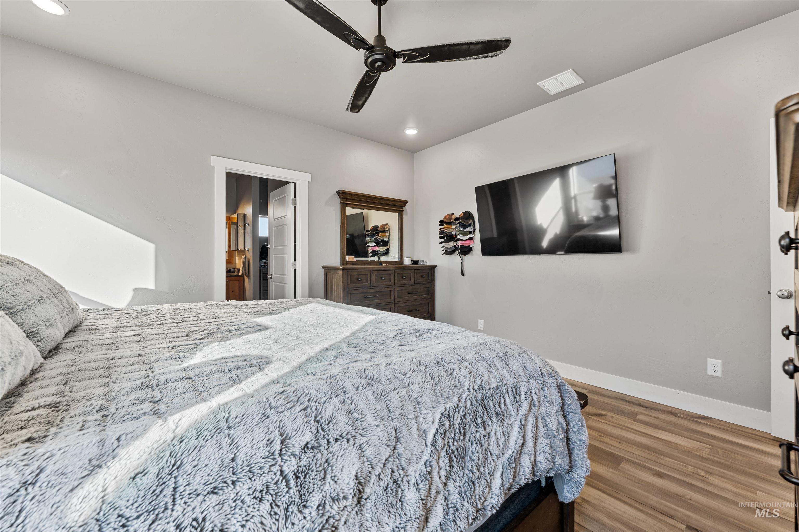 1005 Kenbrook Loop Twin Falls, ID 83301 - Photo 26 of 47 Bedroom with wood finished floors, ceiling fan, recessed lighting, and ensuite bath