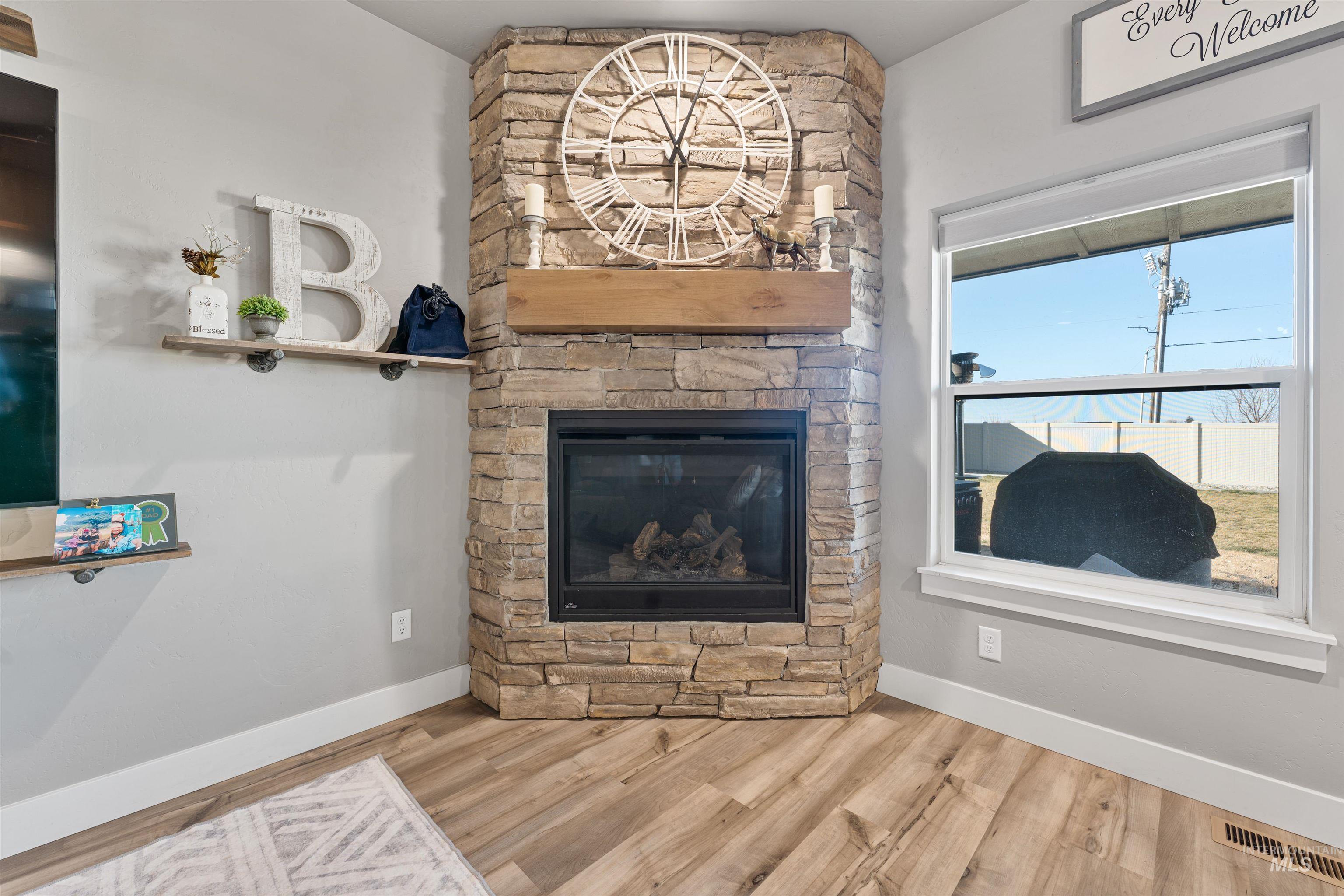 1005 Kenbrook Loop Twin Falls, ID 83301 - Photo 7 of 47 Detailed view of a stone fireplace and wood finished floors