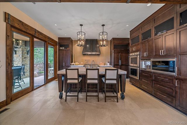 a bathroom with a granite countertop sink a toilet and shower