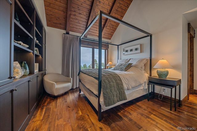 a view of a patio with couches chairs and a fire pit with wooden fence