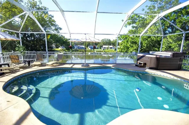 a view of a swimming pool with a yard