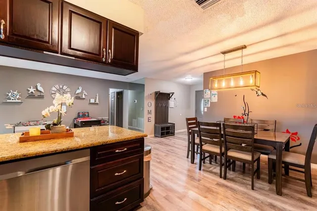 a kitchen with a table chairs and cabinets