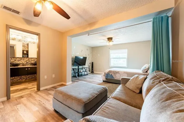 a bedroom with a bed and wooden floor